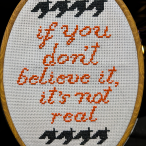 Houndstooth surrounding "If you don't believe it, it's not real"