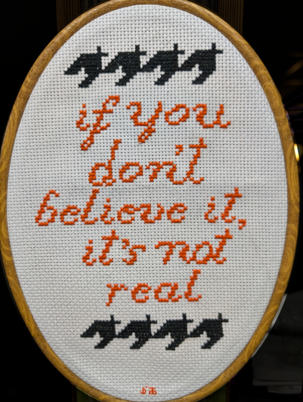 Houndstooth surrounding "If you don't believe it, it's not real"